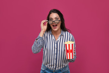 Fototapeta premium Shocked woman with popcorn emotionally looking at camera.