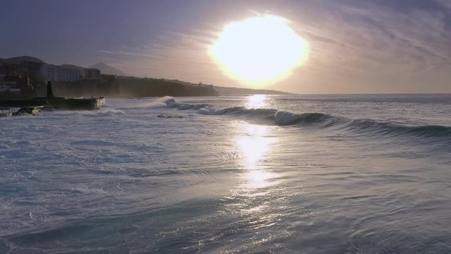 Flying over the Waves of the Ocean to the Sun and the sea Aerial view 4K Wave Splashing Rocky Coast Sea Canary Islands Beach 