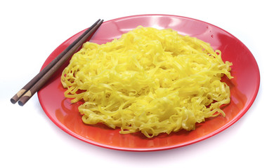 yellow noodles on dish isolated on white background