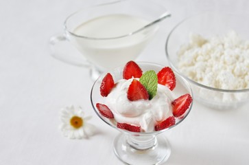 cheese cream. whipped curd cream with strawberries. Homemade cottage cheese is whipped with cream. Chamomile flowers. A useful dessert. On a light background.