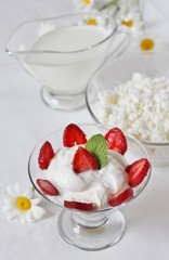 cheese cream. whipped curd cream with strawberries. Homemade cottage cheese is whipped with cream. Chamomile flowers. A useful dessert. On a light background.