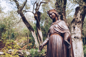 Statue of the Blessed Virgin Mary in her house exterior.