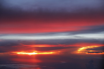Dramatic cloudscape during sunset from the airplane's window