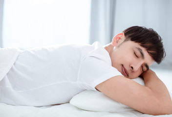 Fototapeta na wymiar Handsome young man sleeping in bed