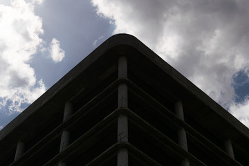 Fototapeta premium Low angle photo of construction building against cloudy sky