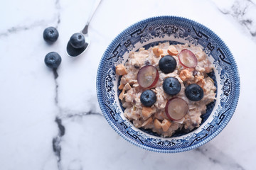 Tasty homemade granola berries on tiles table, closeup. Healthy breakfast.
