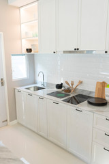 Modern kitchen island and counter with built in cabinets in cozy home.