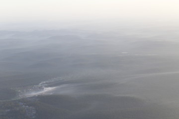 Obraz premium Beautiful landscape during sunrise from the airplane's window