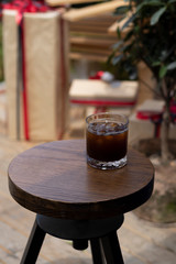 transparent glass of iced black coffee or americano on wooden table