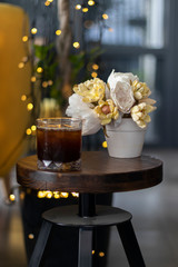 transparent glass of iced black coffee or americano on wooden table
