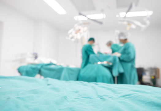 Blurred image background of medical team performing surgical operation in operating room. An operating room may be designed and equipped to provide care to patients.