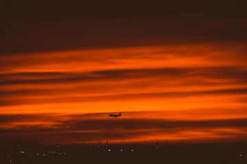 plane landing through the sunset