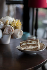 closeup tiramisu cake at coffee shop in a wooden table
