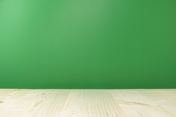 wooden table againt green background. backdrop. copy space