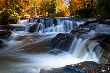 Fototapeta na wymiar Peak autumn colors at Upper Bond Falls, Bond Falls Scenic Site, Michigan.