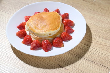 pancake and strawberry fruit sweet dessert food put on breakfast table