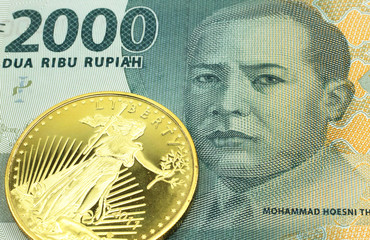 A macro image of a 2000 rupiah bank note from Indonesia with a gold coin.  Shot close up.