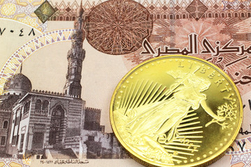 A macro image of a one pound Egyptian pound note with a gold coin.  Shot close up.