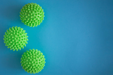 Close up of three green spiky coronavirus models isolated on blue background. Pandemic desease spreading worldwide. Medical treatment of the infected people. Healthcare