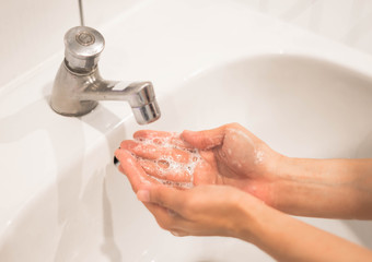 Close up washing hand with running water and soap for stop coronavirus.