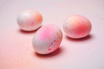 Hand painted Easter eggs on a background of multicolored pastel  - obrazy, fototapety, plakaty