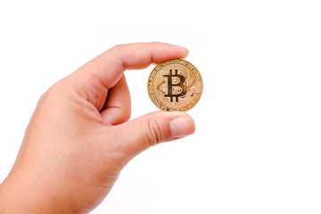 Plakat man hand holding a physical bitcoin in front of a white background