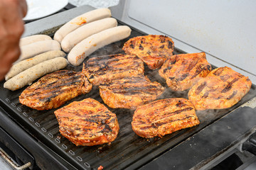 Barbecue grill bbq on coal charcoal grill with steaks bratwurst sausages and meat delicious summer meal