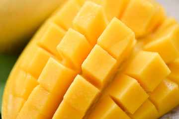 Mango slice and mango leaves from tree tropical summer fruit concept - Close up sweet ripe mangos cut