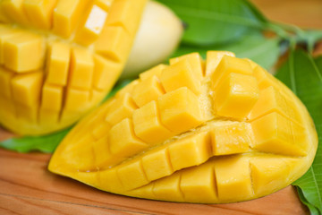 Sweet ripe mangos cut - Mango slice and mango leaves from tree tropical summer fruit concept
