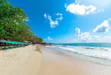 Sea waves on sand beach water and coast seascape - View of beautiful tropical landscape beach sea island with ocean blue sky and resort background in Thailand vacation with chair beach summer and tree