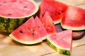 Sliced watermelon on wooden background - Close up fresh watermelon pieces tropical summer fruit