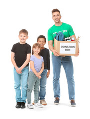 Fototapeta premium Volunteer with donations for orphans and little children on white background