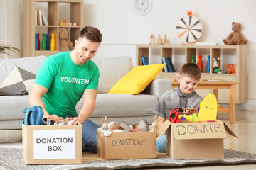 Volunteer with donations and little boy at orphan home