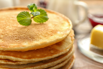 Stack of tasty pancakes on table, closeup