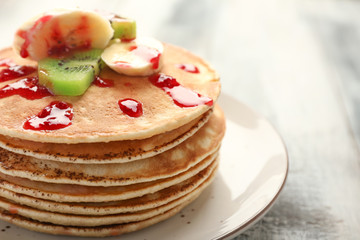 Stack of tasty sweet pancakes on plate