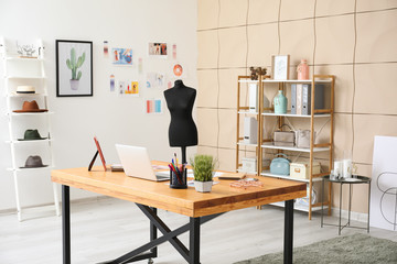 Modern workplace of clothes stylist in office