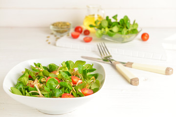 Bowl with tasty salad on white table