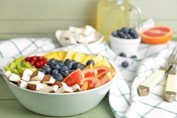 Bowl with tasty salad on table