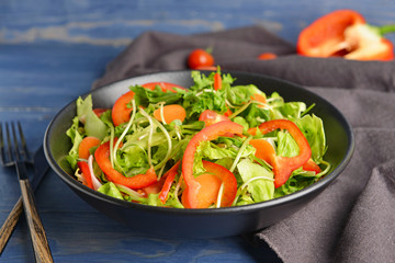 Bowl with tasty salad on table