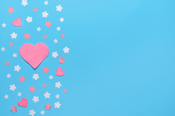 Beautiful hearts with flowers on color background