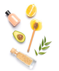 Composition with honey, cosmetics, lemon and avocado on white background