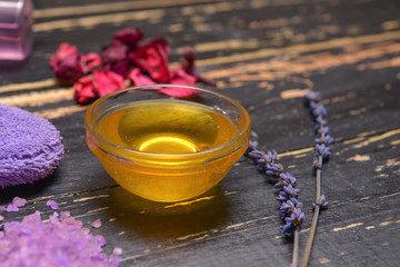 Bowl with honey on dark table