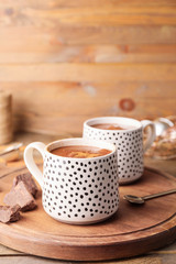 Cups of hot chocolate on wooden table