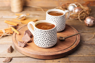Cups of hot chocolate on wooden table