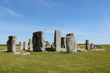 Fototapeta na wymiar View of Stonehenge with green meadow and blue sky on a sunny day in Spring, United Kingdom