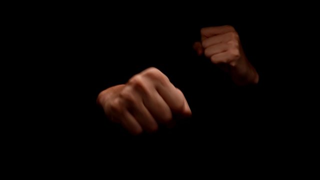 Male hands showing gesture isolated on black background