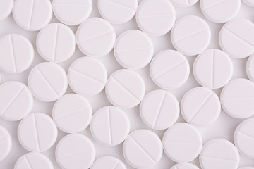 Round white pills background. Many round medicinal pills top view. Background from medicines.