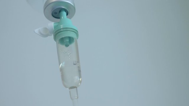 4K Closeup of IV drip in a hospital, Dripping beads of saline in an intensive therapy room