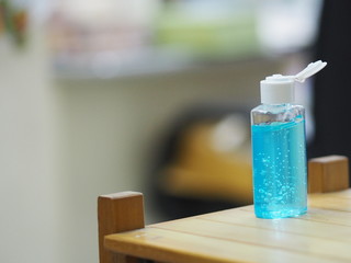 hand wash gel in Plastic bottle on wooden desk, clean to prevent germs protect colona virus, covid 19