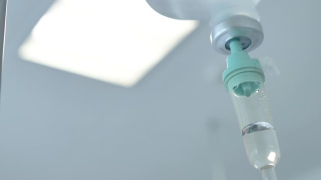 4K Closeup of IV drip in a hospital, Dripping beads of saline in an intensive therapy room